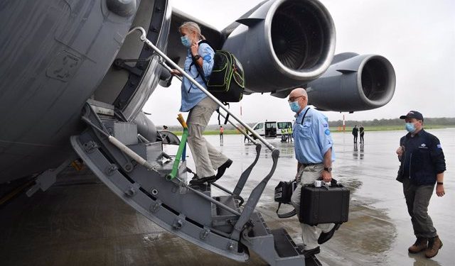 AUSMAT medical team members Angela Jackson (left), Dr Mark Little (centre) and Leigh Cox (right) are seen boarding a C-17A Globemaster at RAAF Base Amberley, west of Brisbane, Tuesday, March 23, 2021. Australia are sending 8,000 doses of its COVID-19 vacc