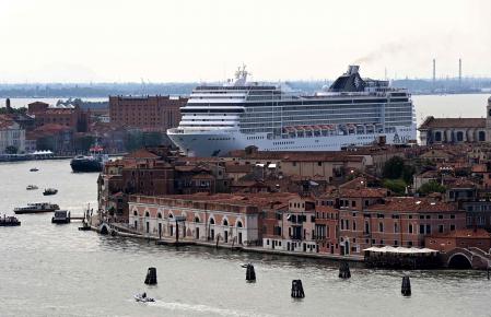 TOPSHOT - The MSC Orchestra cruise ship sails across the basin as it leaves Venice on June 05, 2021. - The cruise ship, which arrived in Venice on June 03, 2021 for the first time in 17 months, signalling the return of tourists after the coronavirus pandemic but enraging those who decry the impact of the giant floating hotels on the world heritage site, picked up about 650 passengers on June 05, before heading south to sample the delights of Bari, Corfu, Mykonos and Dubrovnik. (Photo by MIGUEL MEDINA / AFP)
