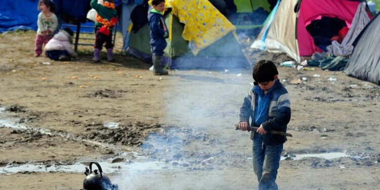 Niños migrantes frente a un campo temporal de refugiados en Idomeni (Grecia). Foto: UNICEF/Tomislav Georgiev