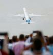 Attendees watch a Boeing 777X aircraft during a display at the Farnborough International Airshow, in Farnborough, Britain, July 20, 2022. REUTERS/Peter Cziborra