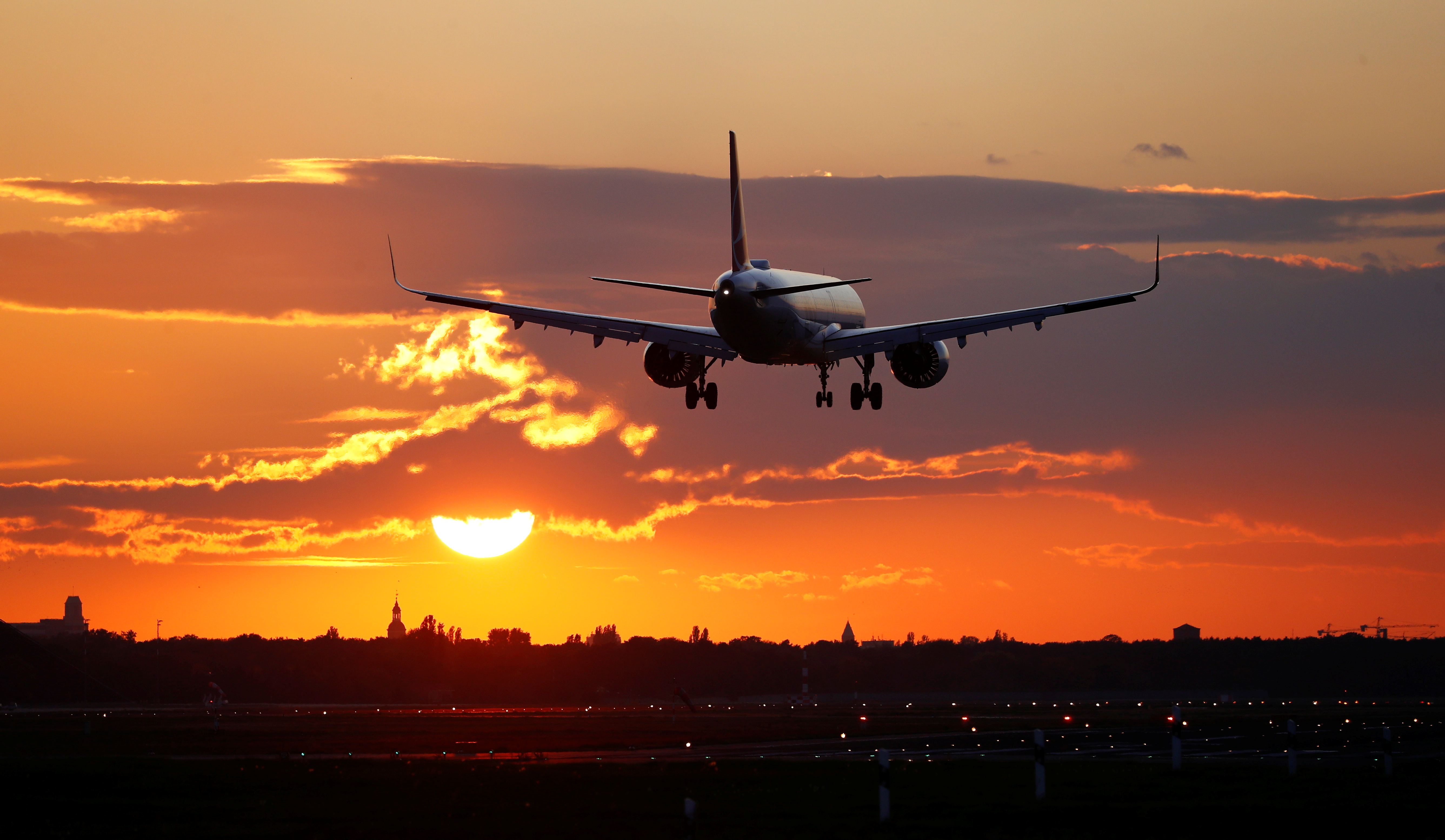 A Turkish Airlines aircraft lands during sunset at Tegel Airport, which is expected to shut permanently on November 8, in Berlin, Germany October 22, 2020. REUTERS/Fabrizio Bensch