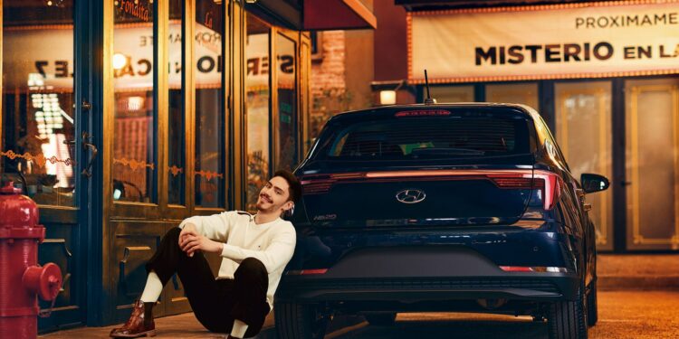 Ivn Amozurrutia sentado y recargado sobre un Hyundai HB20