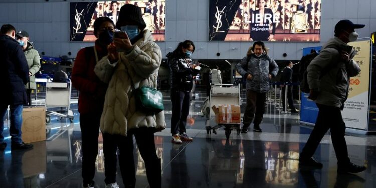 Viajeros junto a su equipaje en el Aeropuerto Internacional de Beijing-Capital, en medio del brote de la enfermedad por coronavirus (COVID-19) en Beijing China, el 27 de diciembre de 2022. REUTERS/Tingshu Wang