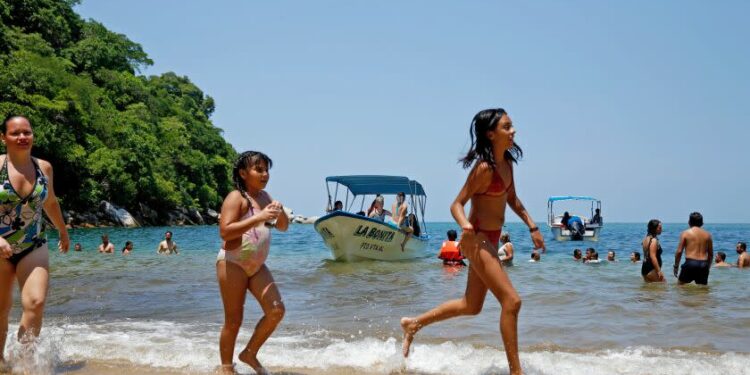 PUERTO VALLARTA, MEX-AUGUST 31, 2019: People take a dip at Colomitos Cove on August 31, 2019 in Puerto Vallarta, Mexico. The hike to Colomitos Cove from Boca de Tomatlan is about 45 minutes. (Photo By Dania Maxwell / Los Angeles Times)