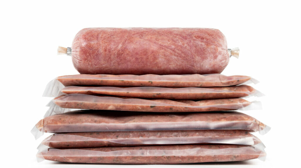 Raw homemade sausage in natural casing isolated on white background.