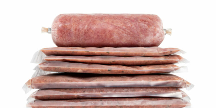 Raw homemade sausage in natural casing isolated on white background.