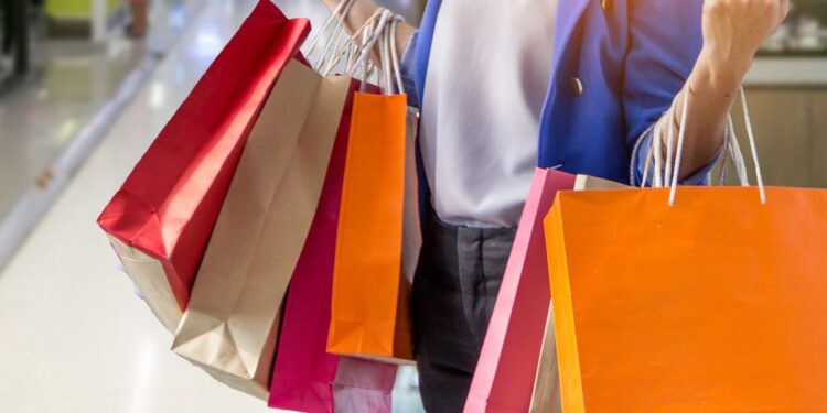 Close up of a woman holding shopping bags, representing top recalls for the week of July 17.