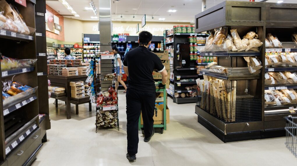 A worker walks around a Metro grocery store in Toronto, Tuesday, July 18, 2023. Metro is donating perishable items to food banks as several store locations across the Greater Toronto Area remain closed as thousands of grocery chain workers enter day five of a strike.THE CANADIAN PRESS/Cole Burston