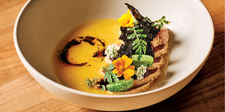 white bowl on wood. orange sauce