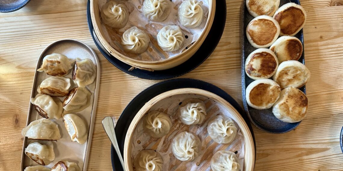 Best soup dumplings in Denver in two baskets with two other plates of dumplings