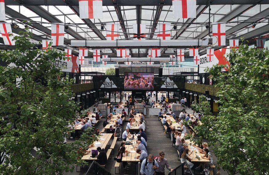 Best food In Croydon: Boxpark with long tables and England flags hanging from the ceiling