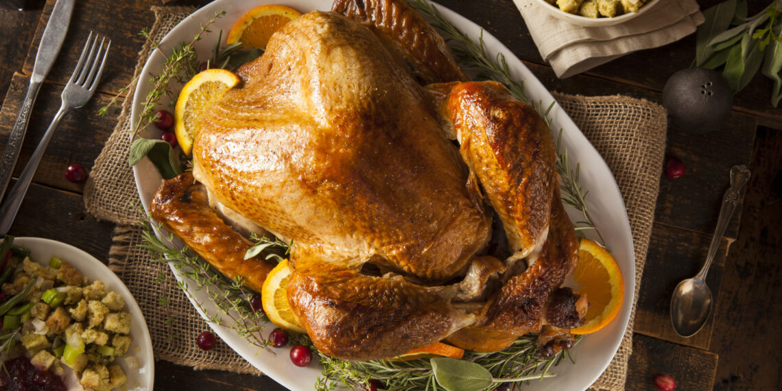 A Thanksgiving turkey on a table as viewed from above. The food safety countdown begins the minute the Thanksgiving feast hits your table.