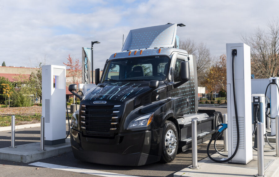 A new eCascadia semitruck sits at a charging station Nov. 16 at Electric Island in Portland. The rig, donated by Daimler Truck, will be used to help collect and sort thousands of pounds of food that Walk &amp; Knock receives every year.