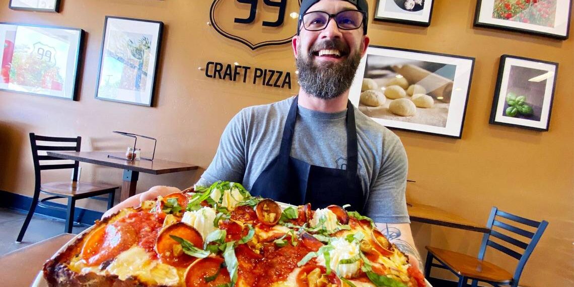 Steve McCrary, partner and general manager at 99 Craft Pizza, shows off Detroit-style pizza in this file photo. His restaurant was voted the best new independent restaurant of 2022 by Bee readers. Voting is open for 2023.