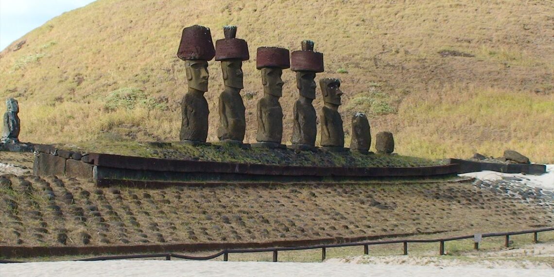 Statues at the base of a hillside on Easter Island.