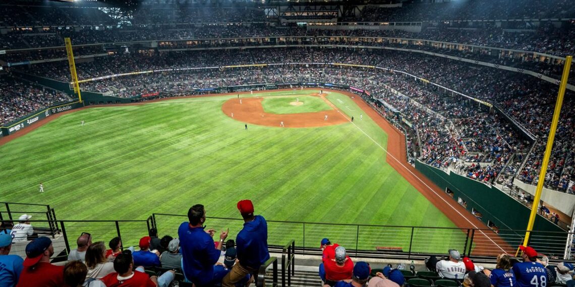 Fans watch an opening day baseball game between the Texas Rangers and the Philadelphia Phillies at Globe Life Field Thursday, March 30, 2023, in Arlington, Texas. (AP Photo/Jeffrey McWhorter)