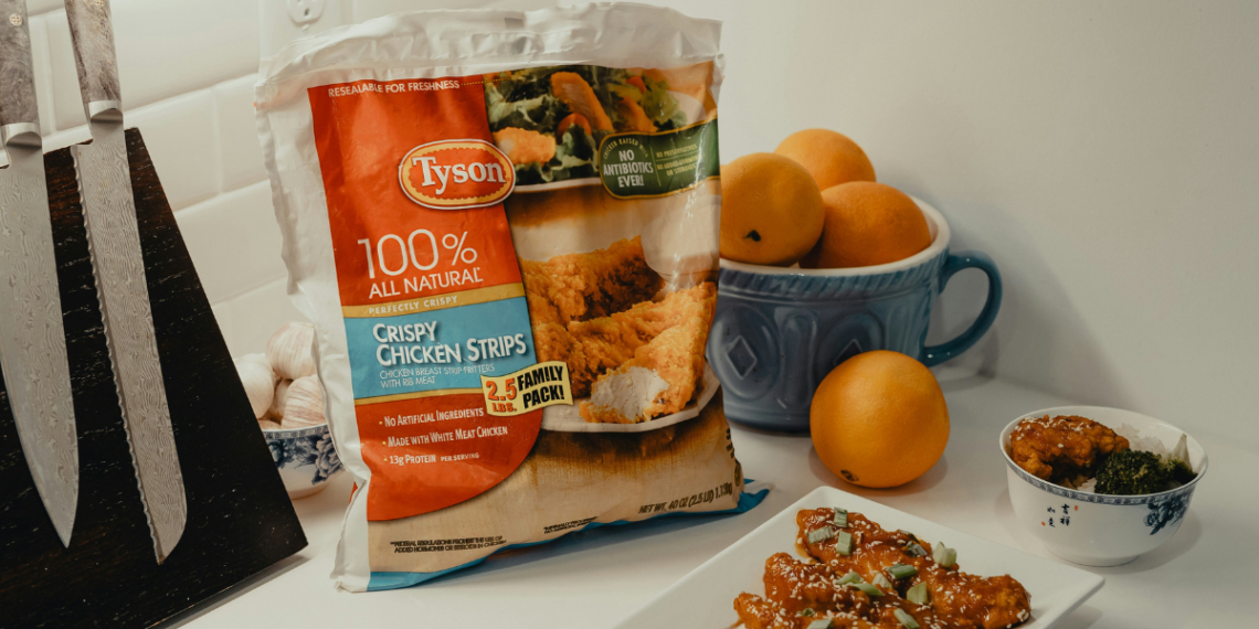 Bag of Tyson chicken on the counter next to a plate of chicken