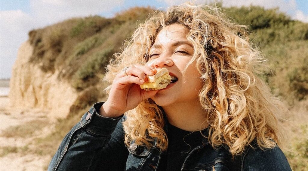 Woman enjoys a bite.