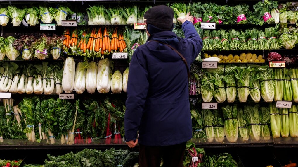 A customer shops for produce at a grocery store In Toronto on Friday, Feb. 2, 2024. (Cole Burston / The Canadian Press)