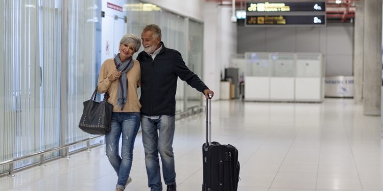 Senior couple traveling airport scene
