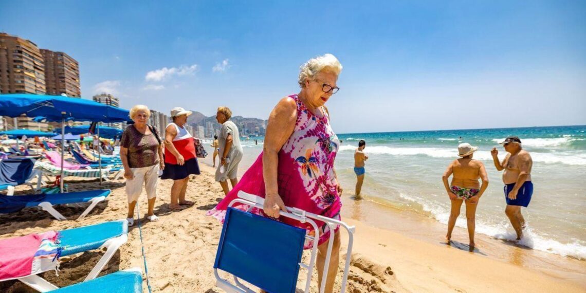 Personas mayores disfrutando de la playa en un viaje del Imserso
